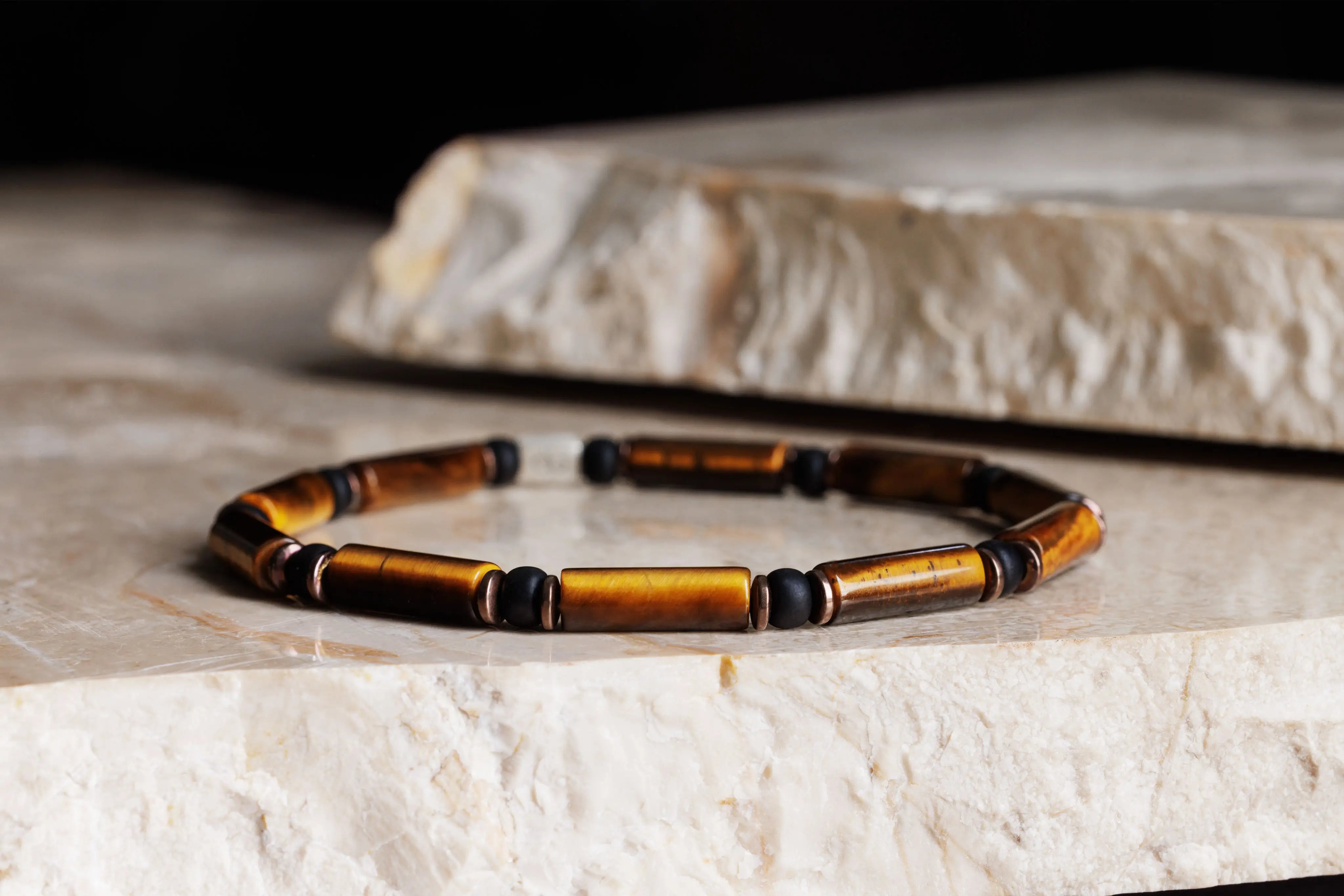 Tiger eye bracelet for men on natural stone surface. 4mm Parvus tube design. Aurum Brothers.