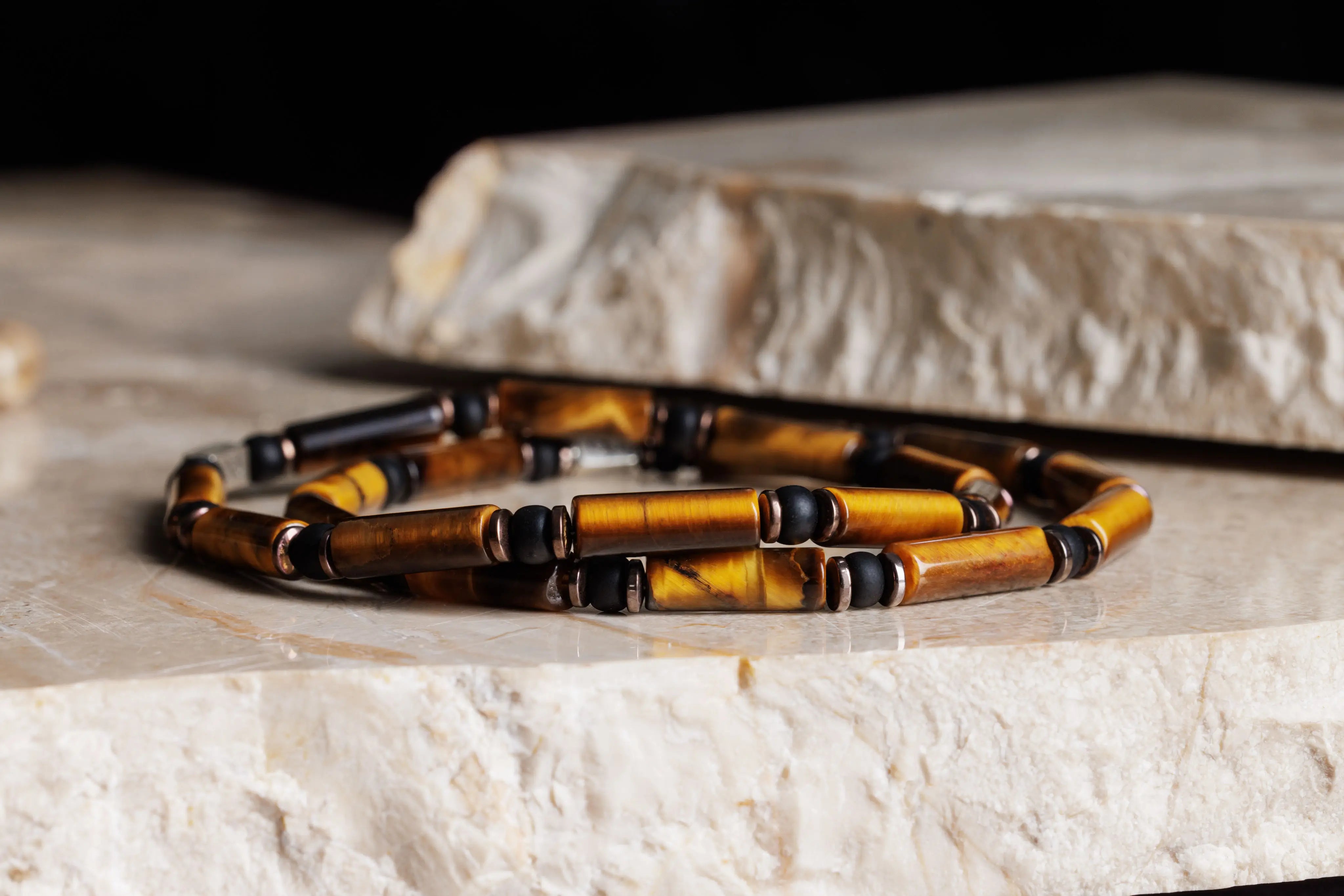 Tiger eye bracelet for men on natural stone, top view. 4mm Parvus tube design. Aurum Brothers.